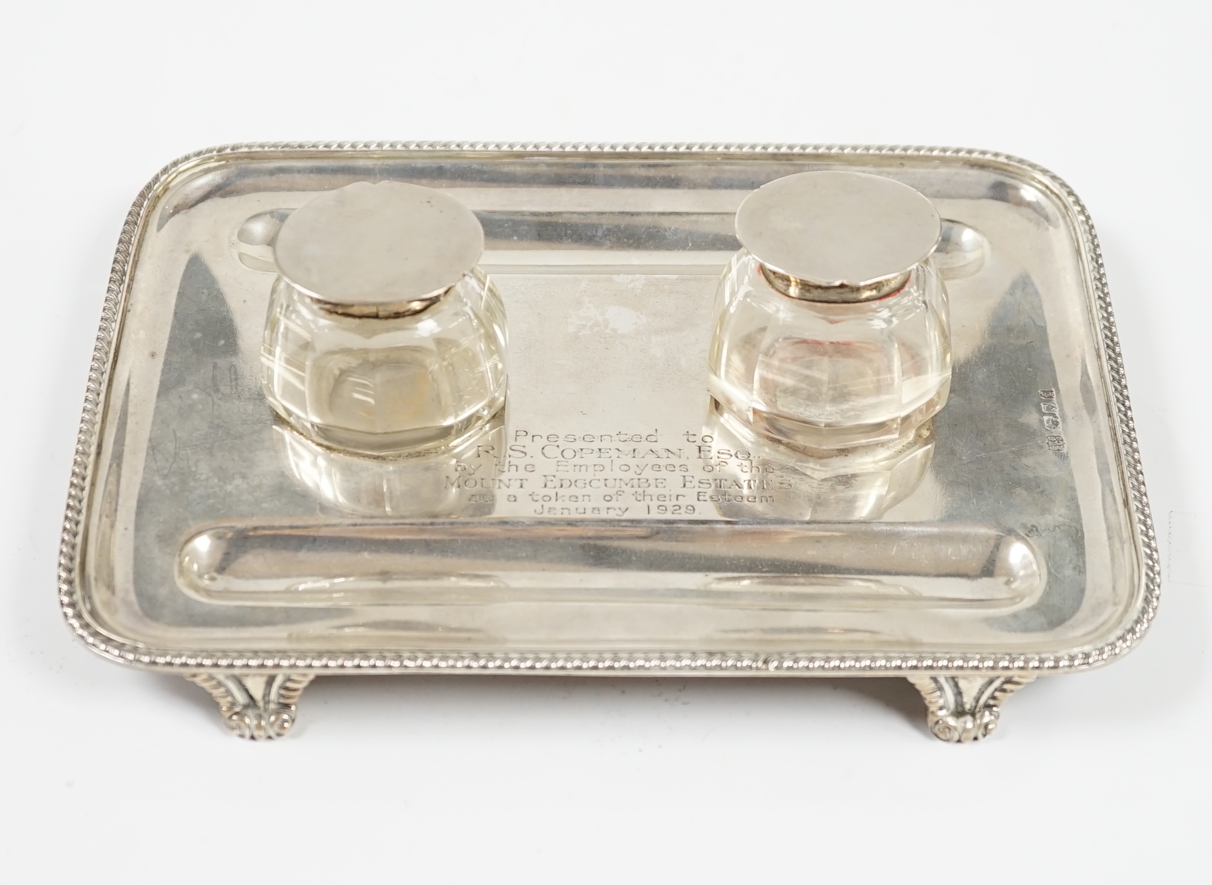 A George V silver inkstand with two silver mounted glass wells, with engraved inscription, S.W. Smith & Co, London, 1921, 21.5cm, 9.6oz. Condition- poor to fair